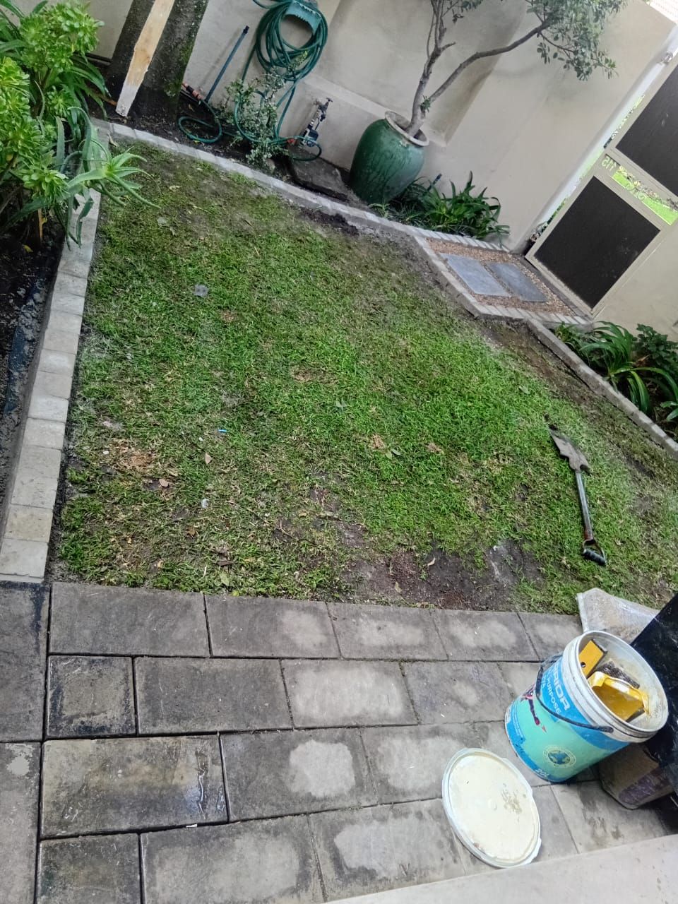 New paving and kerbing alongside a freshly landscaped lawn