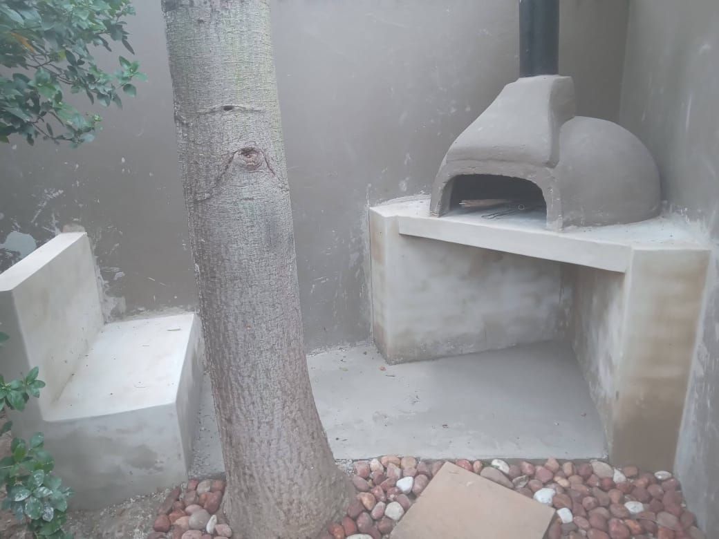 Outdoor pizza oven with built-in concrete seating
