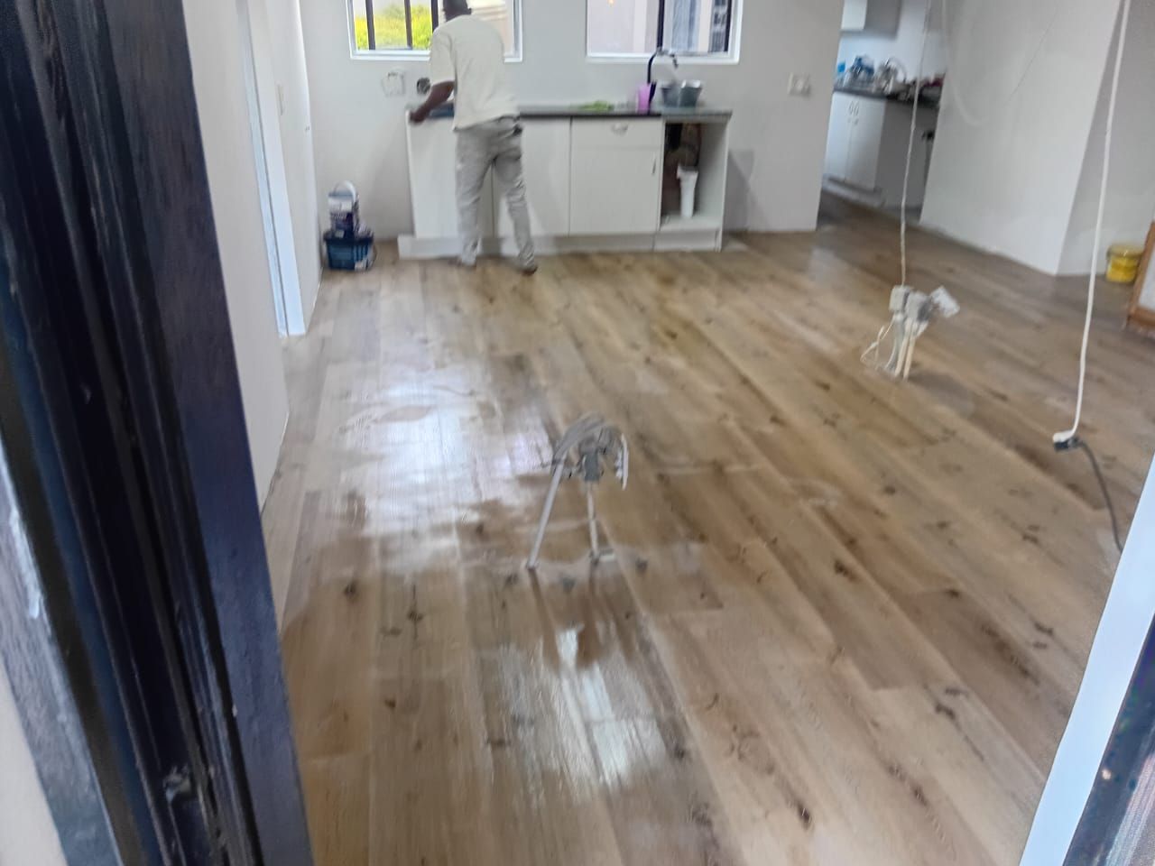 Newly installed vinyl plank floor being cleaned after installation