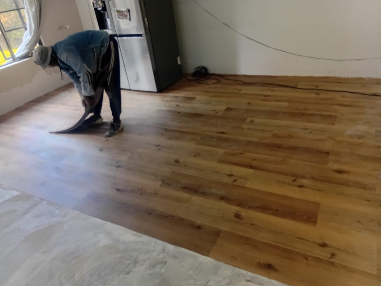 Vinyl plank flooring being laid during installation